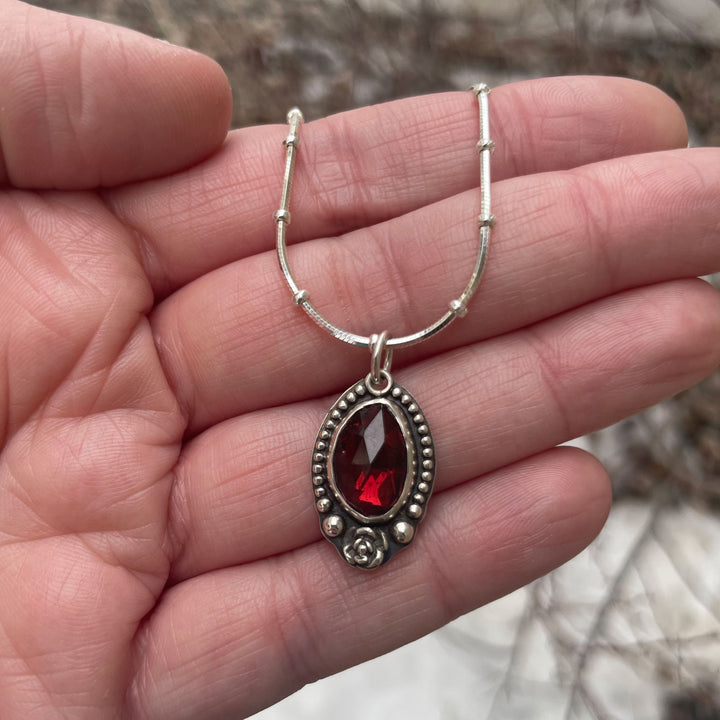 Sterling silver gothic pendant with a red garnet rose.