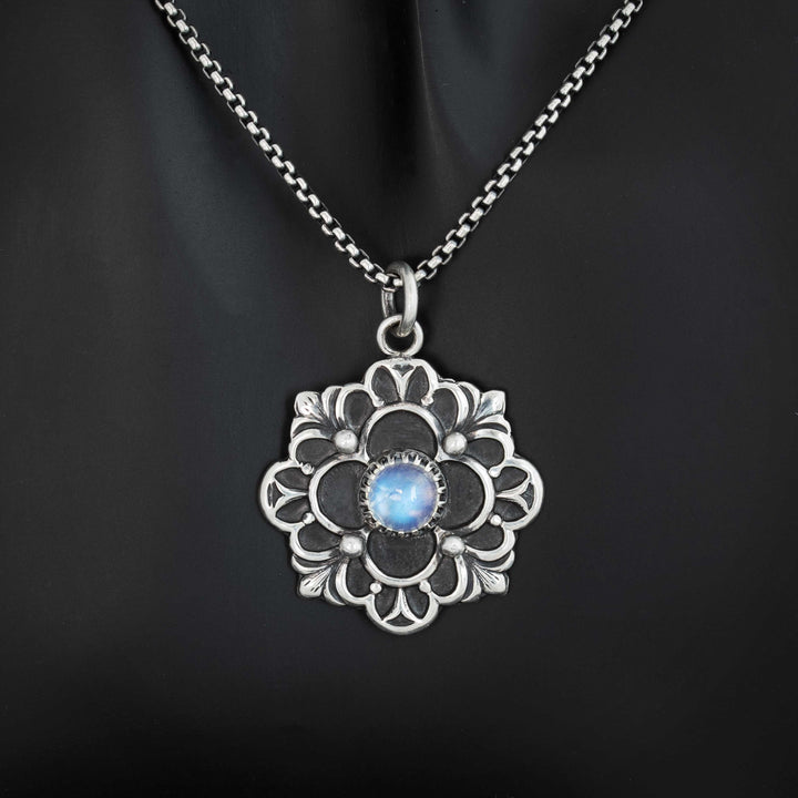 Handcrafted sterling silver gothic flower pendant with brilliant sky blue flash rainbow moonstone cabochon