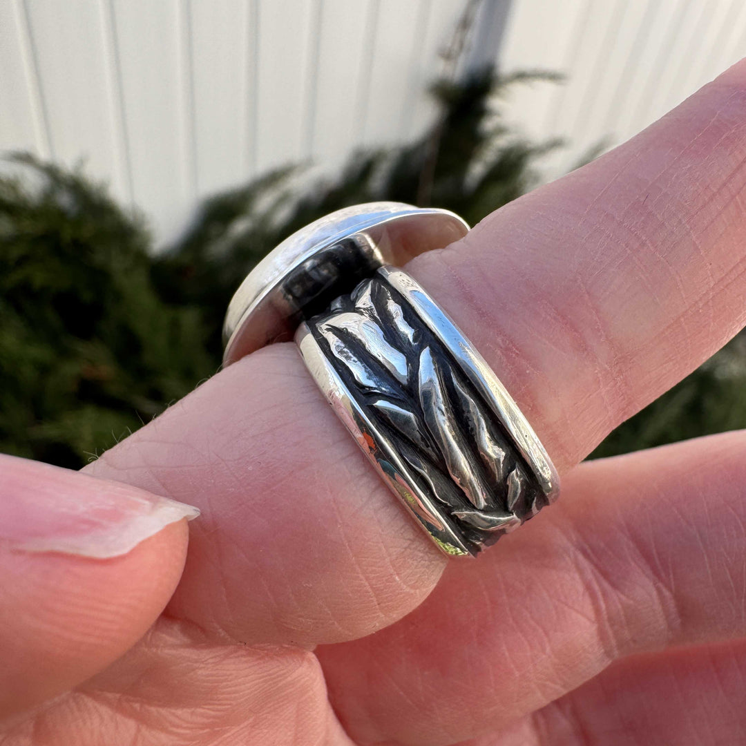 Handmade sterling silver ring with impressed wheat texture band, side profile on hand, Colorado silversmith