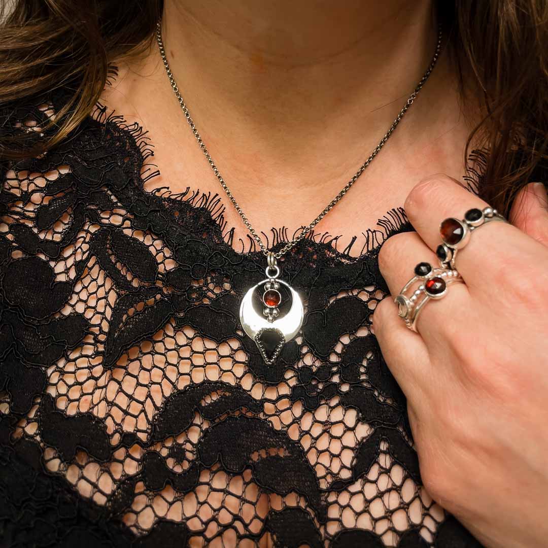 Bat-themed gothic vampire necklace with garnet and black onyx gemstones.