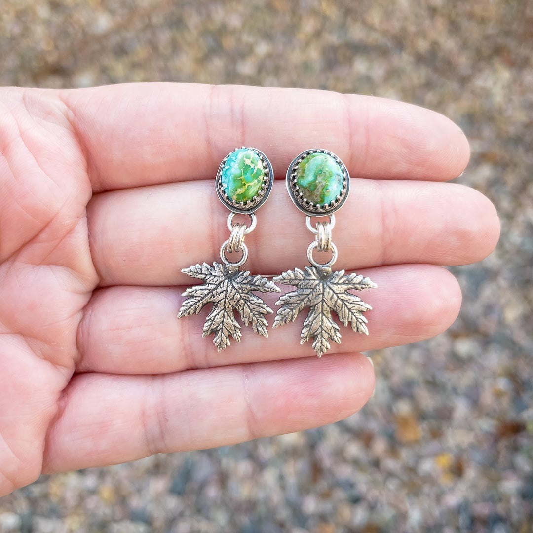 Sonoran Gold turquoise and sterling silver maple leaf earrings displayed in hand