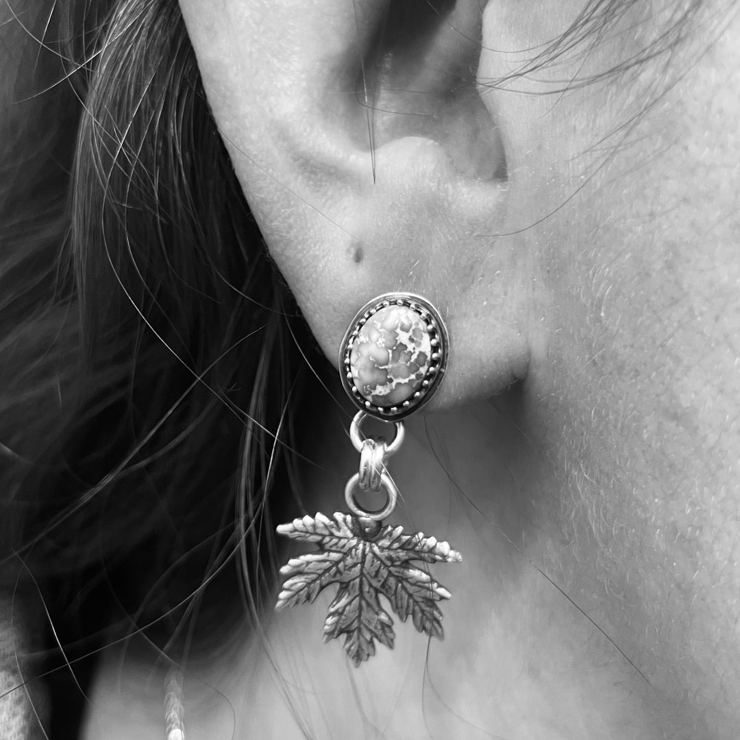 Sterling silver Sonoran Gold turquoise earrings with maple leaf charms shown worn on ear